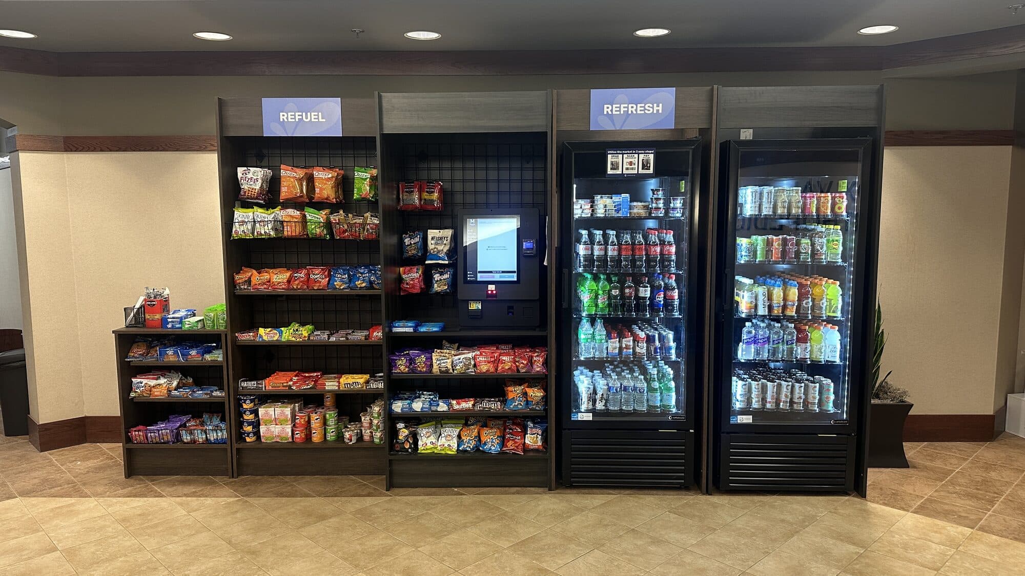 Micro market with shelving and a row of smart coolers